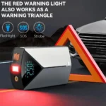 arrancador apoyado sobre su laterla con la luz roja prendida con un triangulo refractario y un auto detras